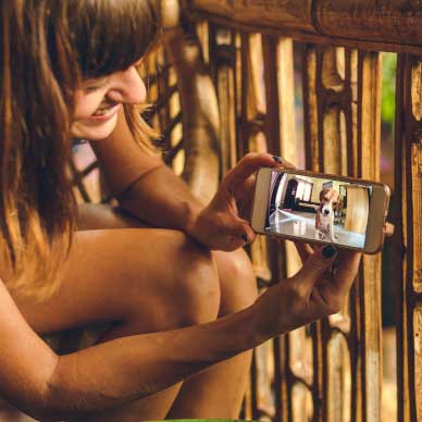 girl looking at dog on phone