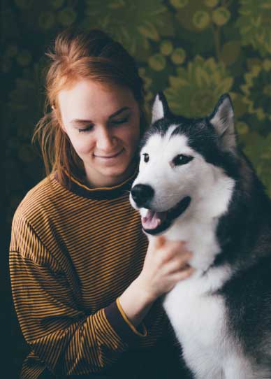 woman posing with dog for a photo