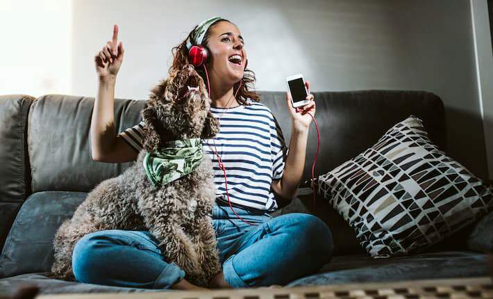 woman and dog listening to music