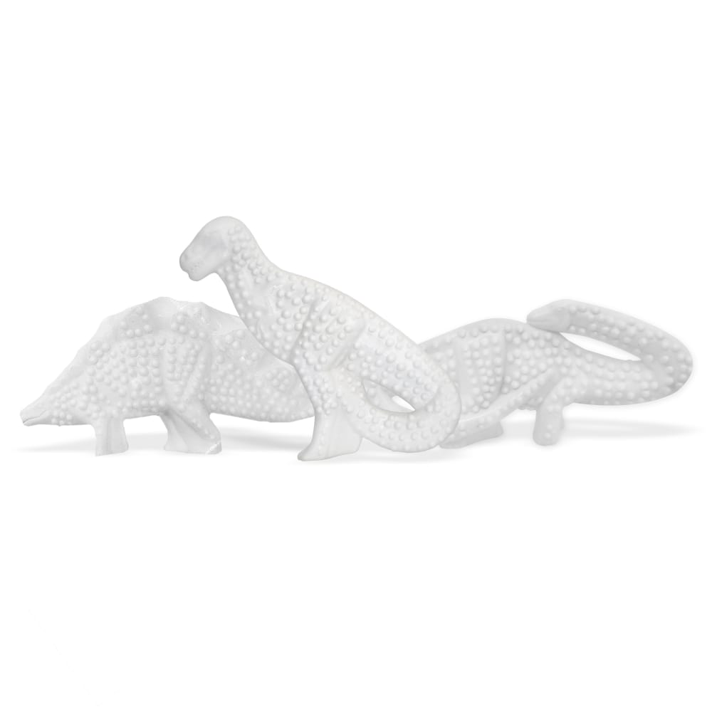 Assortment of white dinosaur-shaped chew toys.